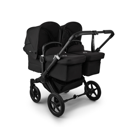 Framsidan av barnevognen Bugaboo Donkey 5 Twin til tvillingar i sort med två liftar